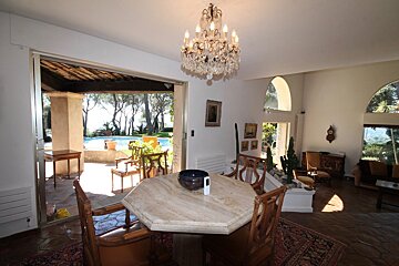 A dining room with a table and chairs and a chandelier