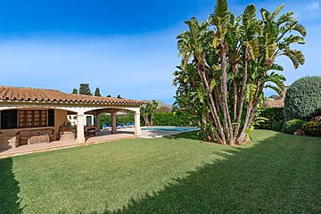 A house with a large lawn in front of it