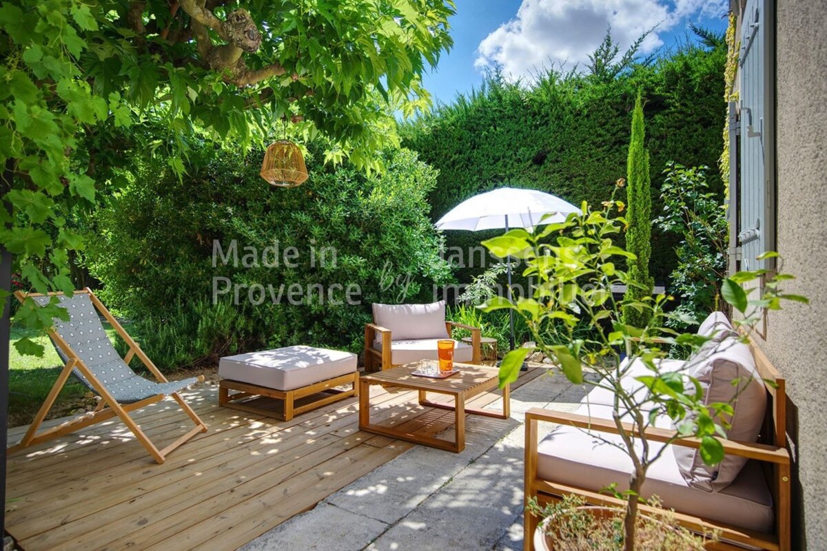 A patio with furniture and an umbrella made in provence