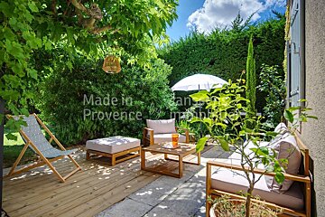 A patio with furniture and an umbrella made in provence
