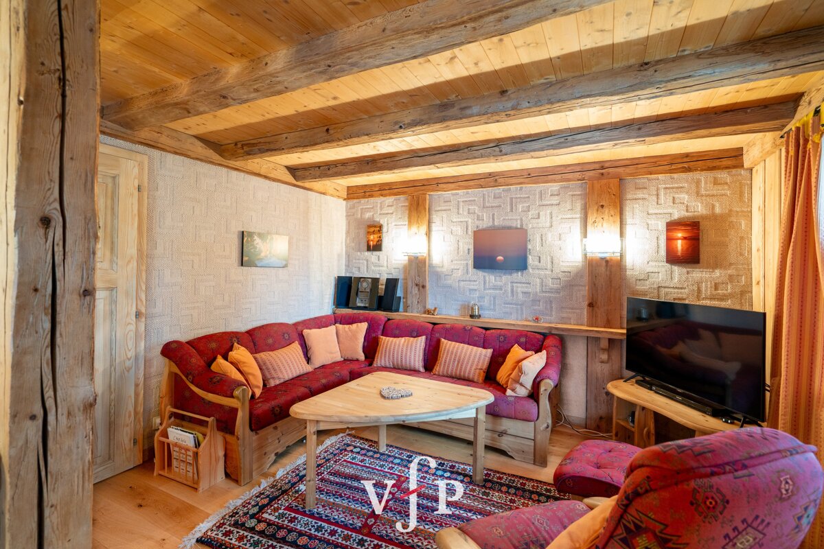 A living room with a sectional couch and a flat screen tv