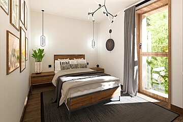 A stylish, modern bedroom with a warm wooden bed, minimalist white walls, framed art, and a large window revealing lush greenery outside.