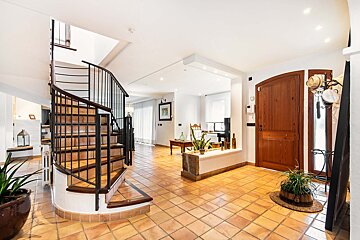 A spiral staircase leads to the second floor of a house