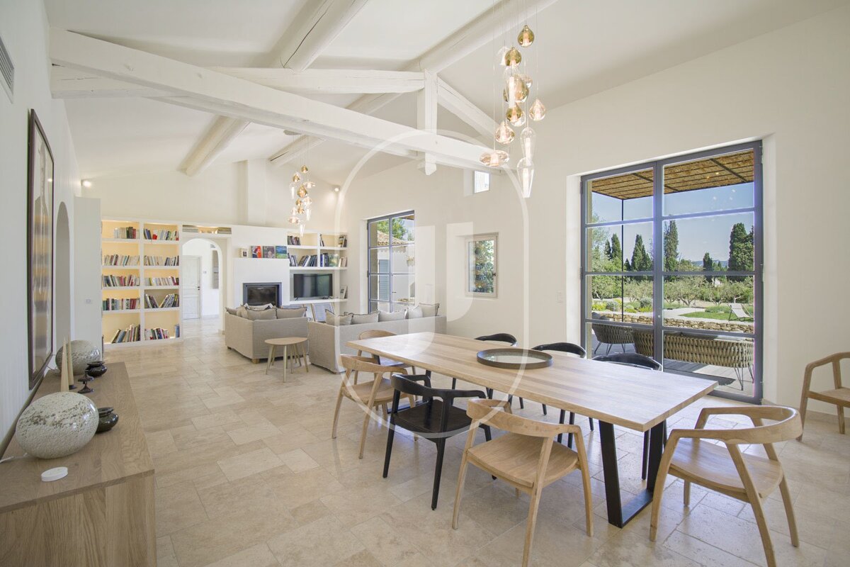 A dining room with a wooden table and chairs