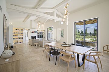 A dining room with a wooden table and chairs