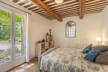 A bedroom with a bed and a mirror that says made in