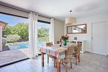 A dining room with a table and chairs and a sign that says made in provence