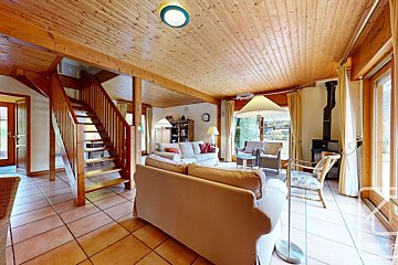 A living room with a staircase leading up to the second floor