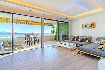 A living room with sliding glass doors leading to a balcony