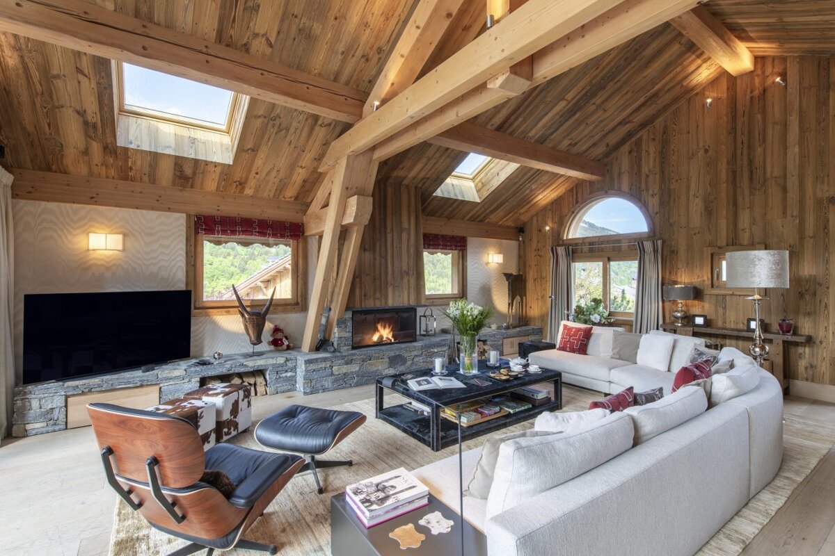 A living room with a vaulted ceiling and a fireplace