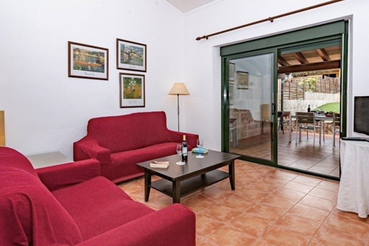 A living room with a red couch and a coffee table