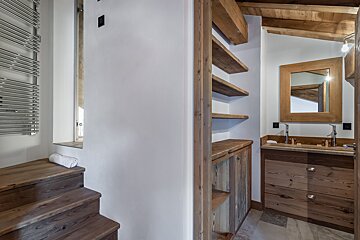 A bathroom with two sinks and a mirror