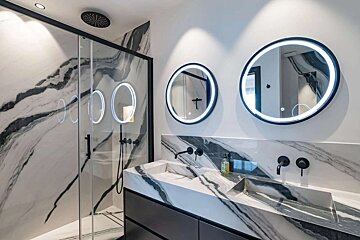 A bathroom with two sinks and two mirrors