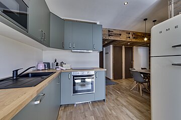 A white smeg refrigerator sits in a kitchen