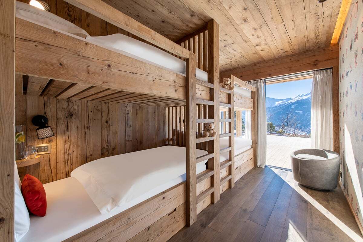 A bunk bed with a view of the mountains in the background