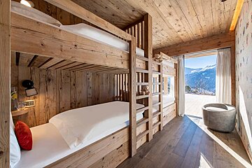 A bunk bed with a view of the mountains in the background