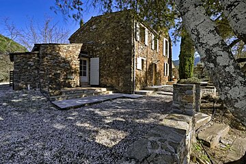 A stone building with a tree in front of it
