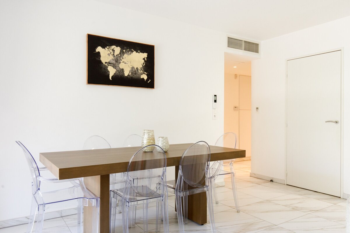 A map of the world hangs above a dining table
