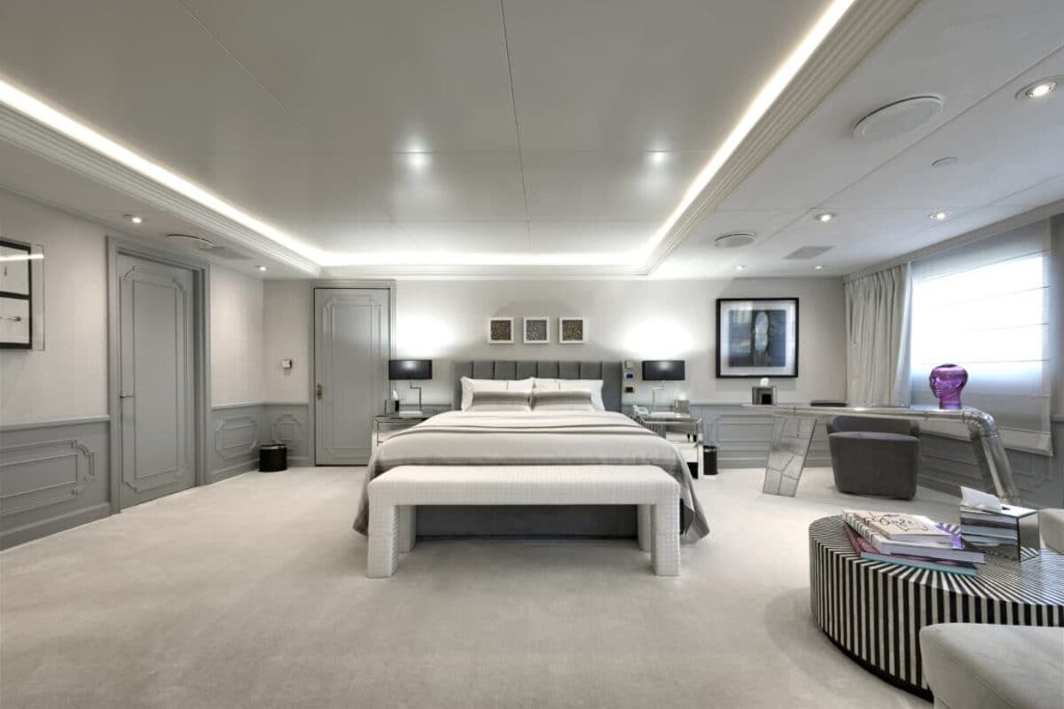 A bedroom with a large bed and a striped table