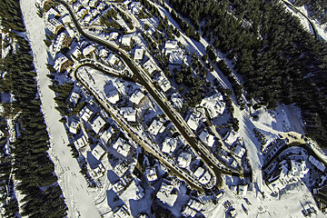 An aerial view of a residential area covered in snow