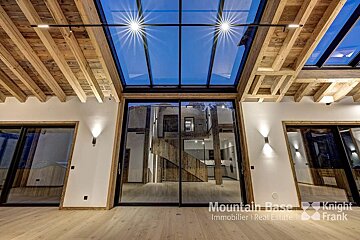 A room with a glass ceiling and a sign that says mountain base