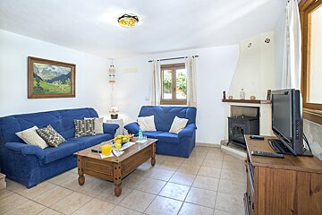 A living room with a blue couch and a television