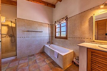 A bathroom with a bathtub and a window