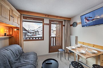 A living room with a flat screen tv showing a skier