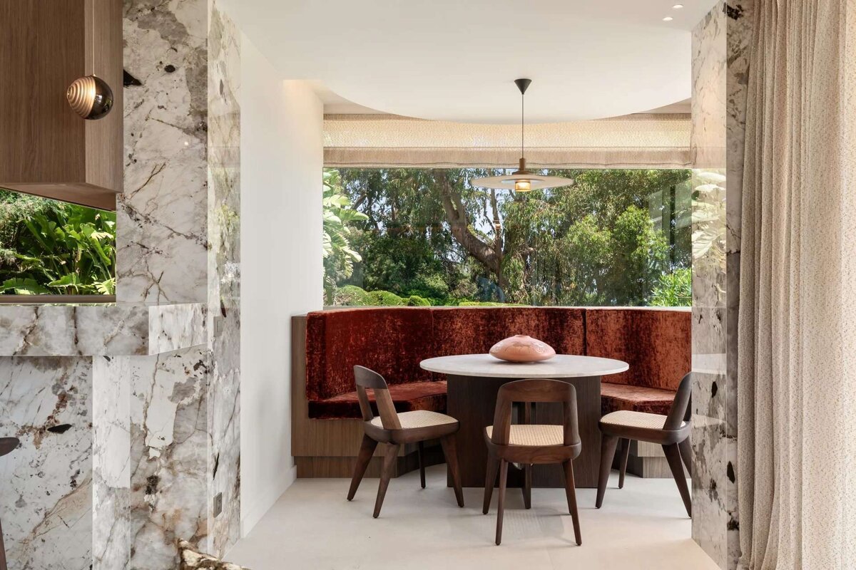 A room with a table and chairs and a window