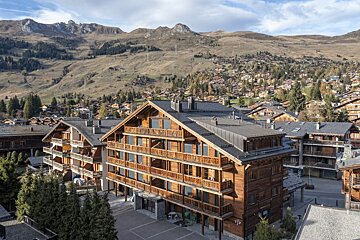 A large wooden building with the number 13 on it