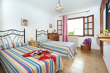 A bedroom with two beds and a magazine on the bed