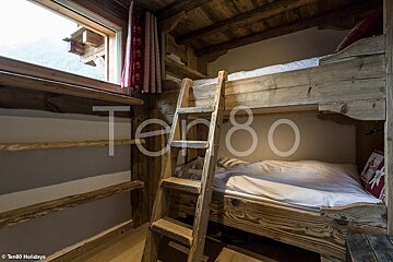 A bunk bed with a ladder and the number 80 on the wall