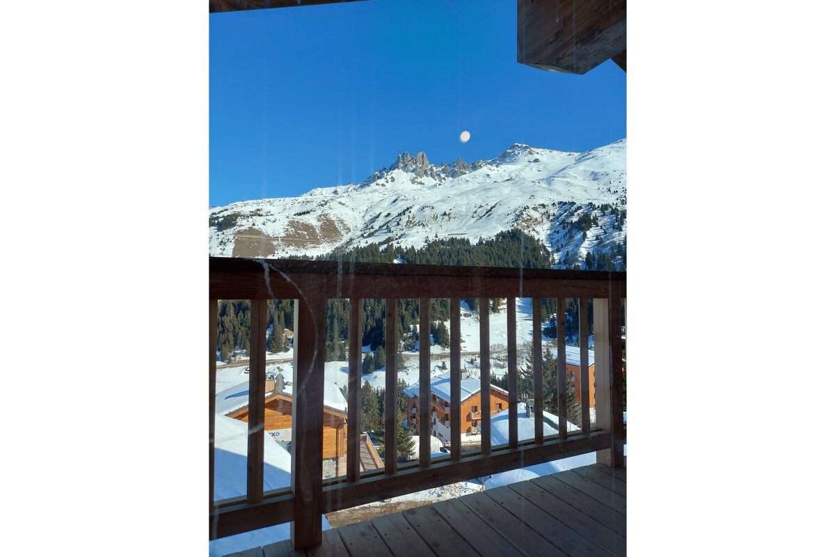 A view of a snowy mountain from a balcony