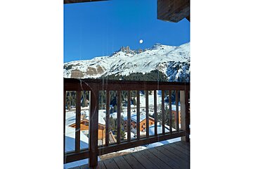 A view of a snowy mountain from a balcony