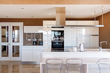 A kitchen with a stove top oven and a coffee maker