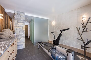 A gym with a treadmill and a bike