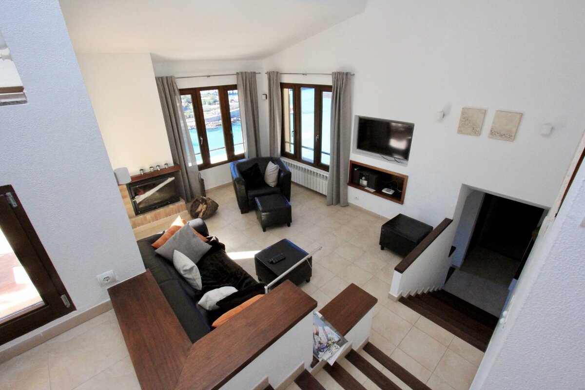 A living room with a couch and chairs and a television