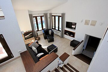 A living room with a couch and chairs and a television