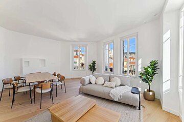 A living room with a couch and a table and chairs