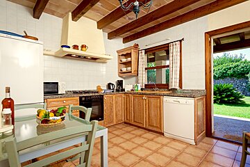 A kitchen with wooden cabinets and a white dishwasher