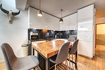 A kitchen with a cow skull hanging above the counter