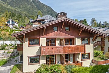 A house with a wooden roof and a balcony