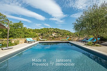 A large swimming pool with the words made in provence by immobilier on the bottom