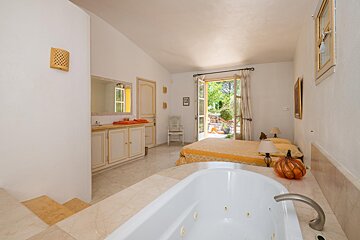 A bathroom with a jacuzzi tub and a bed