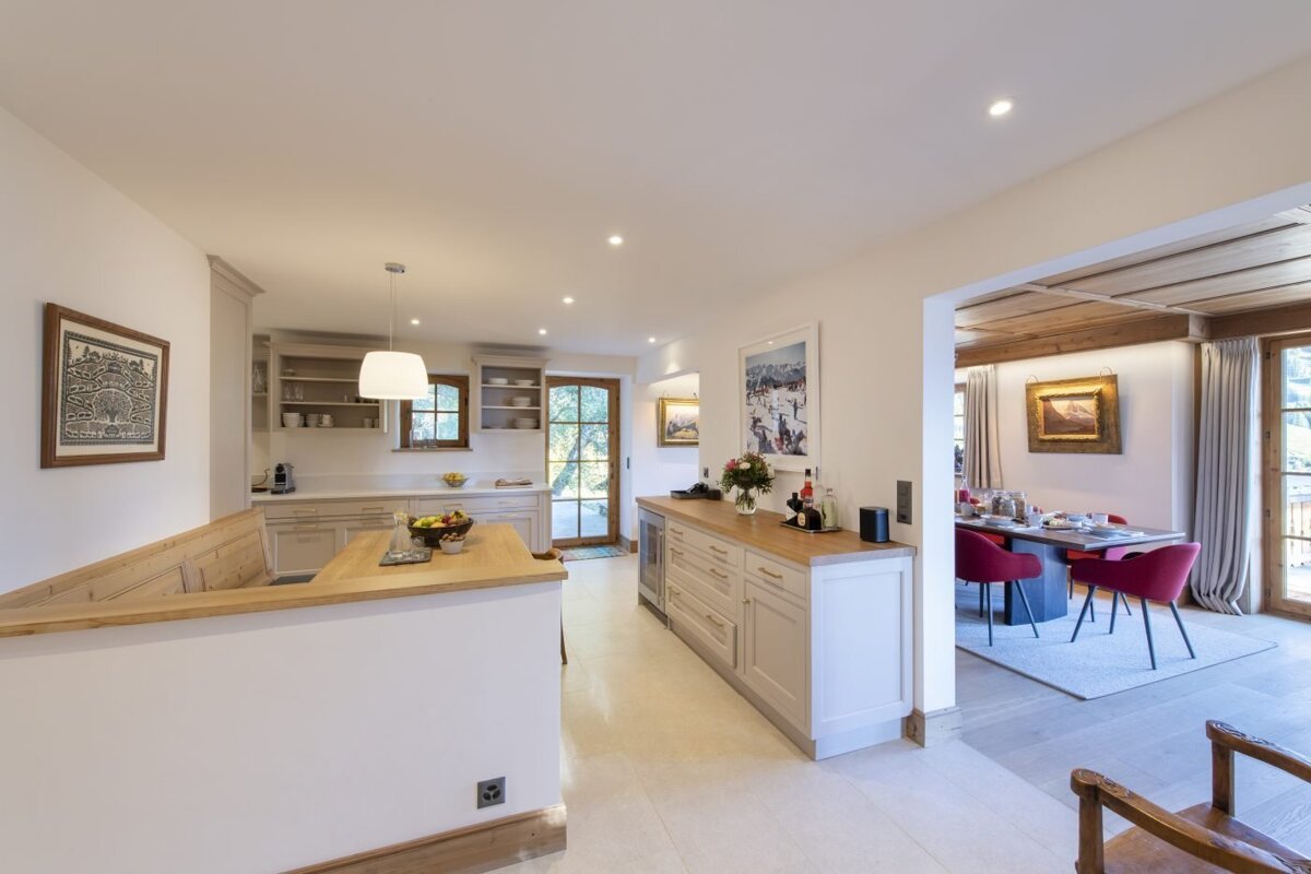 A kitchen with white cabinets and wooden counter tops