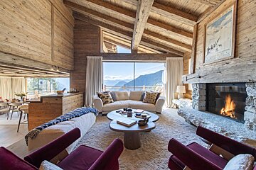 A living room with a couch and chairs and a fireplace