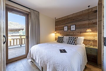 A bedroom with a bed and a book on it