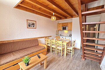 A living room with a couch a table and chairs