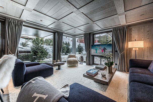 A living room with a couch a chair and a tv