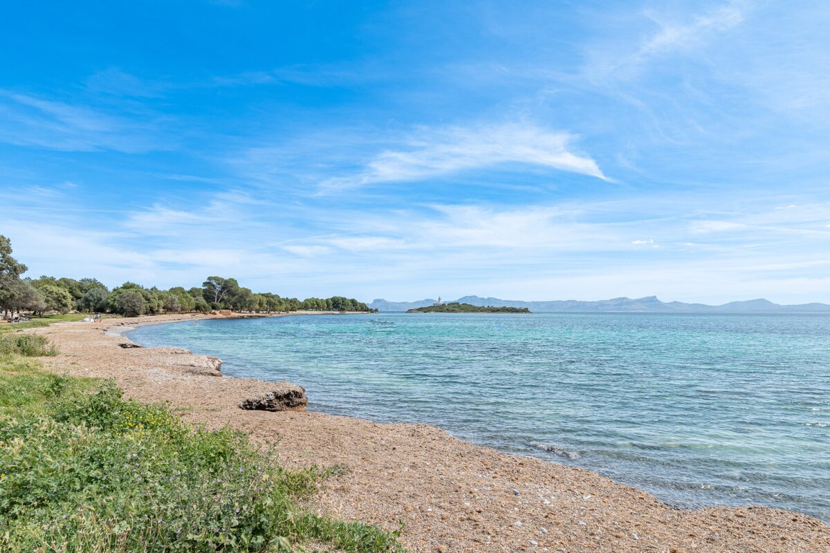 A large body of water with mountains in the background